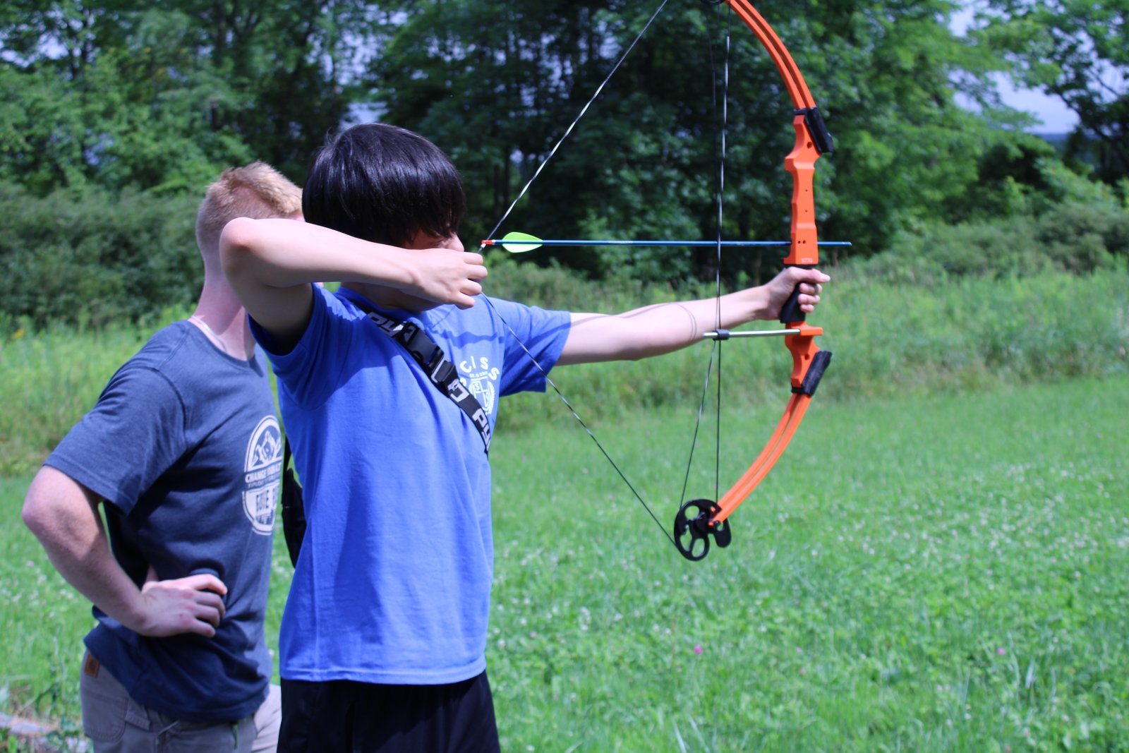 Student practicing archery outdoors